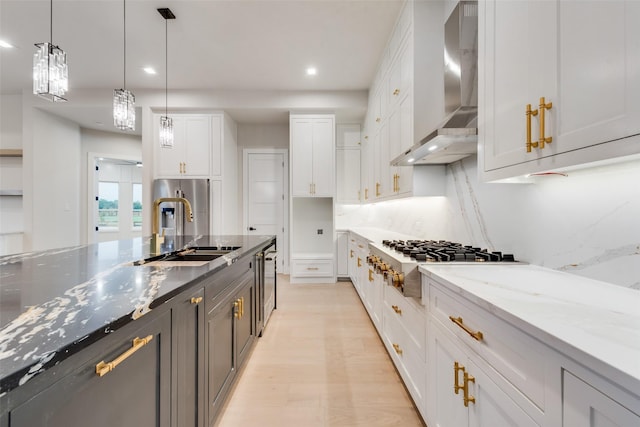 1700 Hamilton Ln, Northlake, TX 76247 - kitchen featuring wall chimney range hood, a sink, stainless steel gas stovetop, white cabinetry, and light stone counters