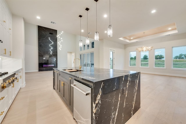 1700 Hamilton Ln, Northlake, TX 76247 - kitchen with appliances with stainless steel finishes, a sink, open floor plan, a chandelier, and white cabinetry