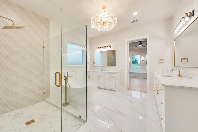 1700 Hamilton Ln, Northlake, TX 76247 - bathroom featuring a shower stall, a soaking tub, two vanities, a chandelier, and marble finish flooring