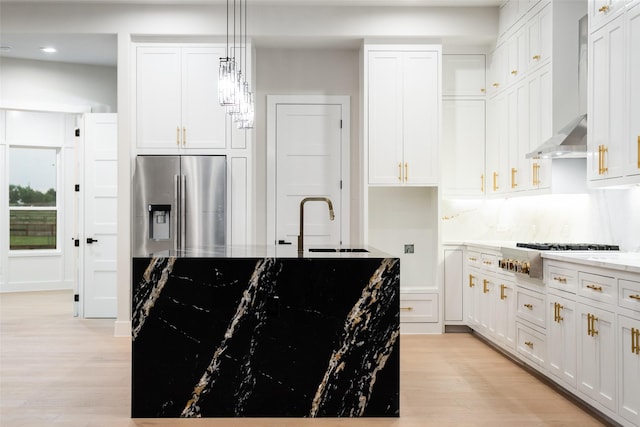 1700 Hamilton Ln, Northlake, TX 76247 - kitchen with appliances with stainless steel finishes, wall chimney range hood, a sink, light wood-type flooring, and recessed lighting