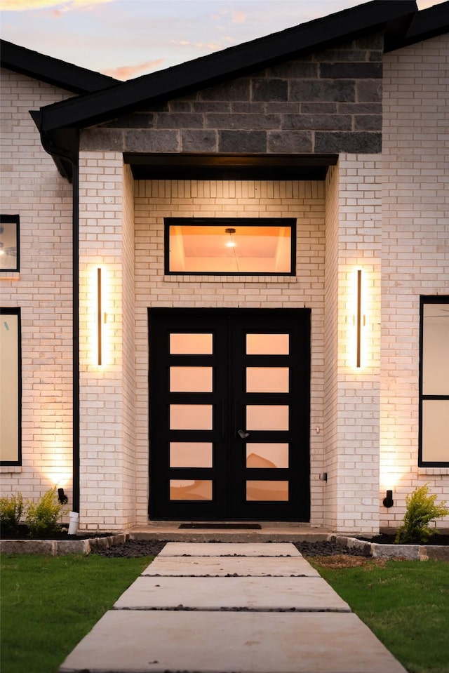 1700 Hamilton Ln, Northlake, TX 76247 - exterior entry at dusk featuring french doors and brick siding