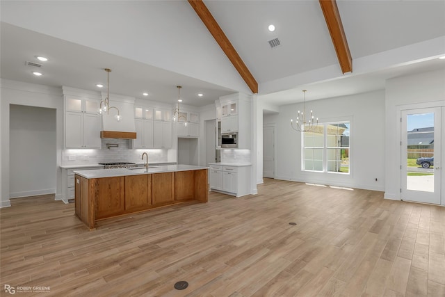 39 Turtle Creek Dr, Benton, LA 71006 - kitchen with a chandelier, stainless steel appliances, backsplash, light countertops, and beam ceiling