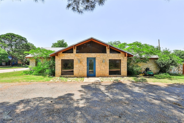 920 SW 3rd St, Hamlin, TX 79520 - view of front of house featuring stone siding, a standing seam roof, and metal roof