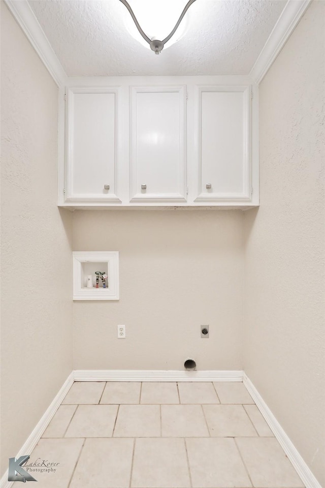 920 SW 3rd St, Hamlin, TX 79520 - laundry room featuring washer hookup, cabinet space, a textured ceiling, electric dryer hookup, and baseboards