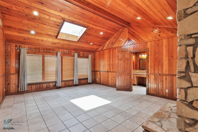 920 SW 3rd St, Hamlin, TX 79520 - unfurnished living room featuring wooden walls, a skylight, lofted ceiling, light tile patterned floors, and wood ceiling