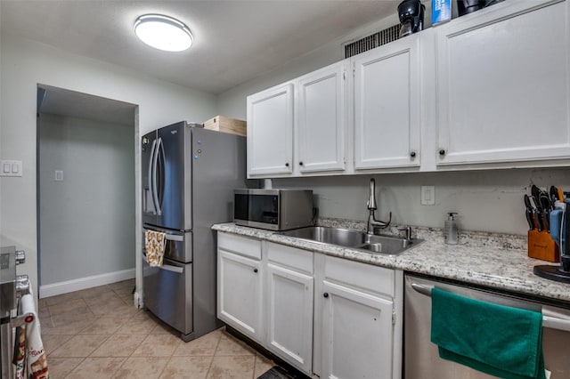 3232 Bunker Hill Dr, Forest Hill, TX 76140 - kitchen with appliances with stainless steel finishes, a sink, white cabinets, and baseboards