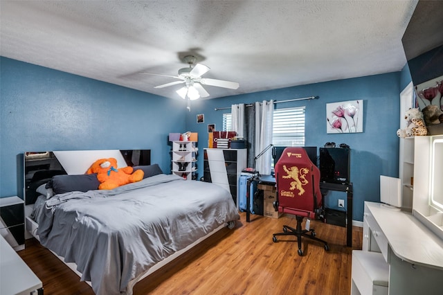 3232 Bunker Hill Dr, Forest Hill, TX 76140 - bedroom with wood finished floors, a textured ceiling, ceiling fan, and baseboards