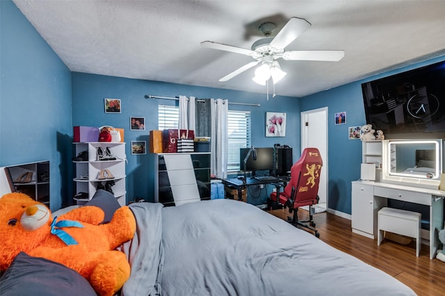 3232 Bunker Hill Dr, Forest Hill, TX 76140 - bedroom featuring wood finished floors, baseboards, a ceiling fan, and a textured ceiling