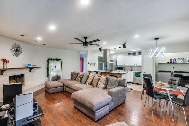 3232 Bunker Hill Dr, Forest Hill, TX 76140 - living area with light wood-style flooring, recessed lighting, ceiling fan, washer / dryer, and a fireplace