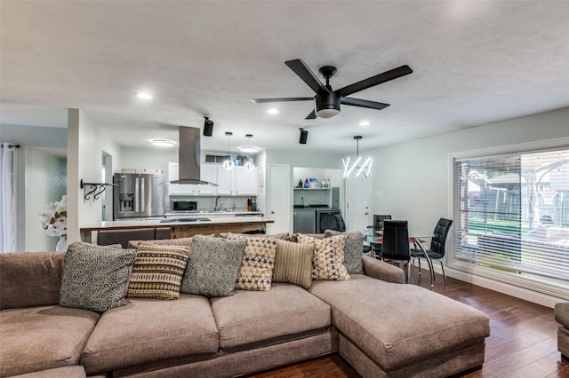 3232 Bunker Hill Dr, Forest Hill, TX 76140 - living room with ceiling fan, recessed lighting, dark wood-style flooring, washing machine and clothes dryer, and a chandelier