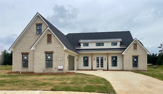 45 Turtle Creek Dr, Benton, LA 71006 - view of front of home featuring french doors, driveway, board and batten siding, a front yard, and a standing seam roof