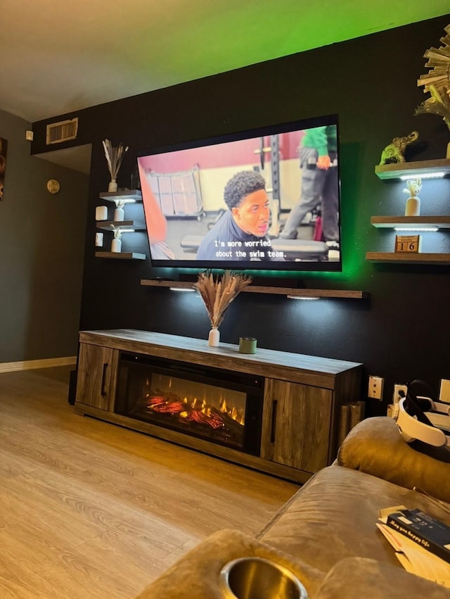 1213 Southridge Dr, Lancaster, TX 75146 - detailed view of wood finished floors, a glass covered fireplace, and baseboards