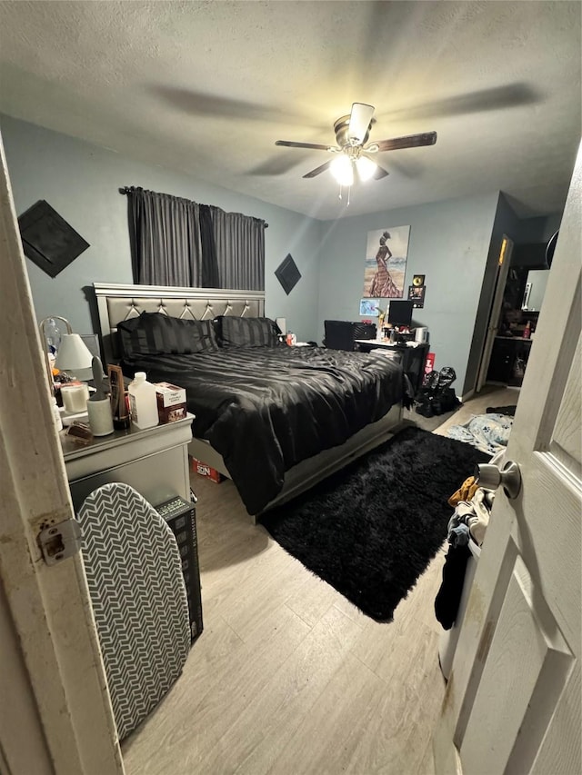 1213 Southridge Dr, Lancaster, TX 75146 - bedroom featuring wood finished floors, a ceiling fan, and a textured ceiling