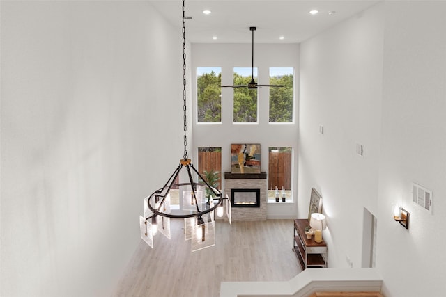 5634 Barkridge Dr, Granbury, TX 76048 - living room featuring wood finished floors, a fireplace, recessed lighting, a ceiling fan, and a high ceiling
