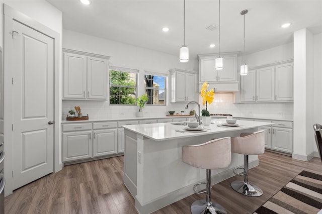 12947 Cabana Dr, Frisco, TX 75035 - kitchen featuring light countertops, a center island with sink, white cabinets, and recessed lighting