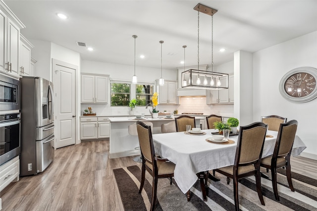 12947 Cabana Dr, Frisco, TX 75035 - dining room with light wood-style floors and recessed lighting