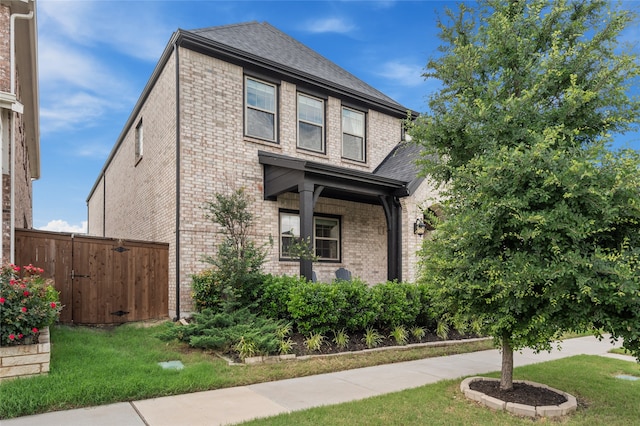 12947 Cabana Dr, Frisco, TX 75035 - view of front of house featuring brick siding, roof with shingles, and a gate