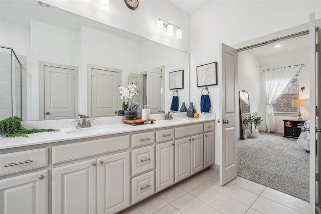 12947 Cabana Dr, Frisco, TX 75035 - full bathroom featuring double vanity, tile patterned flooring, and a tile shower