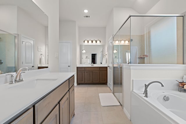 1052 Winecup Ln, Weatherford, TX 76085 - full bath with a shower stall, a garden tub, two vanities, and tile patterned floors