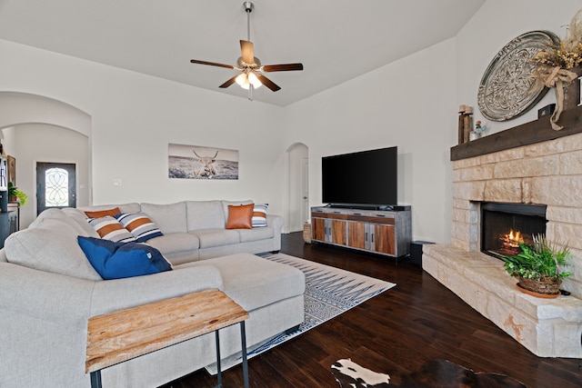 1052 Winecup Ln, Weatherford, TX 76085 - living room featuring arched walkways, hardwood / wood-style floors, a ceiling fan, and a stone fireplace
