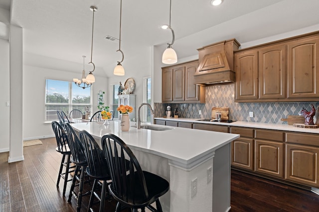 1052 Winecup Ln, Weatherford, TX 76085 - kitchen with a sink, premium range hood, black electric cooktop, backsplash, and recessed lighting