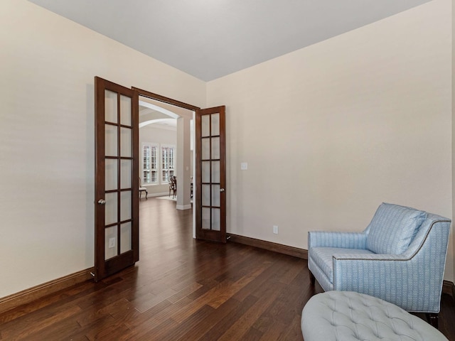 1025 Arches Park Dr, Allen, TX 75013 - sitting room with french doors, wood finished floors, arched walkways, and baseboards