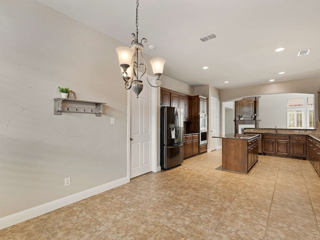 1025 Arches Park Dr, Allen, TX 75013 - kitchen with appliances with stainless steel finishes, a chandelier, a sink, a center island, and recessed lighting