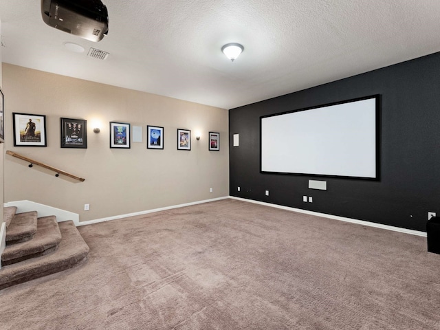 1025 Arches Park Dr, Allen, TX 75013 - carpeted home theater with a textured ceiling and baseboards