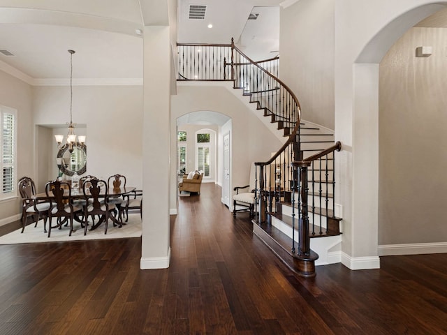 1025 Arches Park Dr, Allen, TX 75013 - foyer entrance featuring arched walkways, plenty of natural light, stairs, ornamental molding, and a towering ceiling
