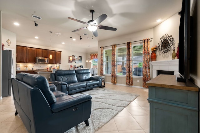 1129 Mesa Crest Dr, Fort Worth, TX 76052 - living area featuring light tile patterned floors, a ceiling fan, recessed lighting, a fireplace, and baseboards
