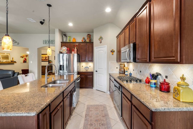 1129 Mesa Crest Dr, Fort Worth, TX 76052 - kitchen featuring appliances with stainless steel finishes, a sink, tasteful backsplash, light tile patterned flooring, and decorative light fixtures