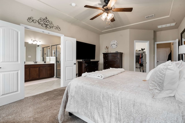 1129 Mesa Crest Dr, Fort Worth, TX 76052 - bedroom with light tile patterned floors, a spacious closet, a sink, a closet, and light colored carpet