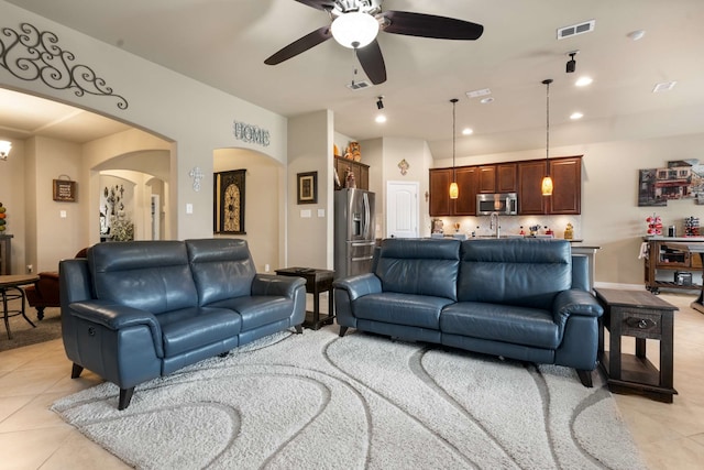 1129 Mesa Crest Dr, Fort Worth, TX 76052 - living area featuring light tile patterned floors, arched walkways, a ceiling fan, and recessed lighting