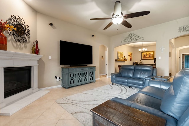 1129 Mesa Crest Dr, Fort Worth, TX 76052 - living area featuring arched walkways, light tile patterned floors, a fireplace, and ceiling fan