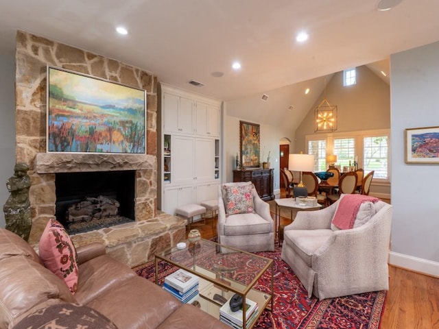 6319 Mccommas Blvd, Dallas, TX 75214 - living room with light wood finished floors, baseboards, a fireplace, recessed lighting, and vaulted ceiling