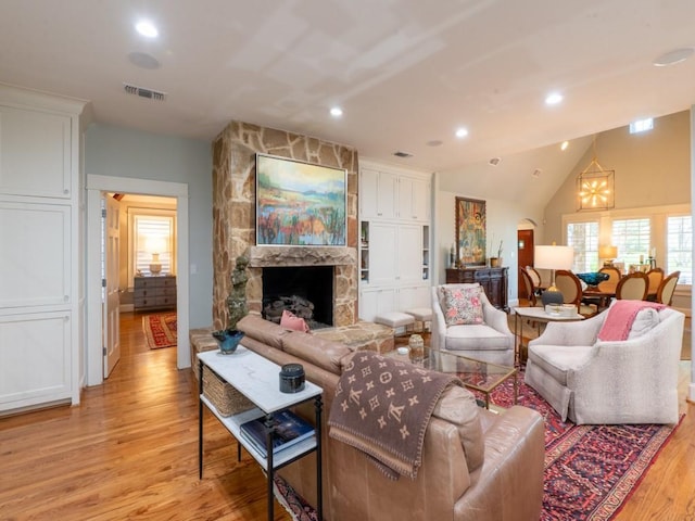 6319 Mccommas Blvd, Dallas, TX 75214 - living area featuring light wood finished floors, a fireplace, recessed lighting, a chandelier, and lofted ceiling