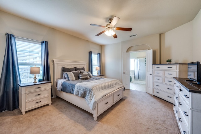 5825 Loveland Dr, Denton, TX 76208 - bedroom featuring light carpet, multiple windows, ensuite bath, and a ceiling fan