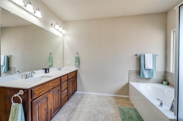 5825 Loveland Dr, Denton, TX 76208 - bathroom with double vanity, a bath, baseboards, and tile patterned floors