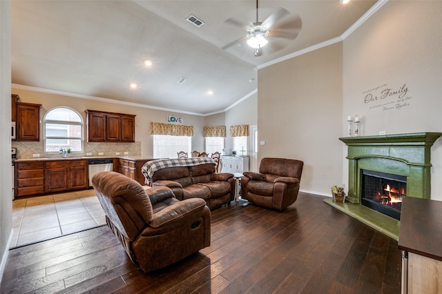 5825 Loveland Dr, Denton, TX 76208 - living area with ceiling fan, light wood-style flooring, a warm lit fireplace, ornamental molding, and recessed lighting