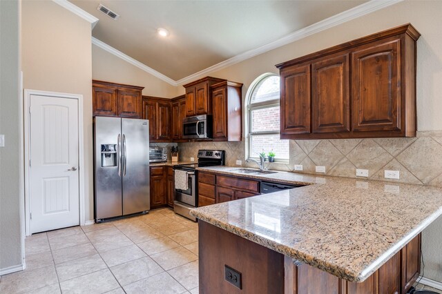 5825 Loveland Dr, Denton, TX 76208 - kitchen featuring appliances with stainless steel finishes, a peninsula, a sink, light stone counters, and vaulted ceiling