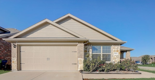 2113 Rubin Rd, Fate, TX 75189 - single story home with concrete driveway, a garage, and stone siding
