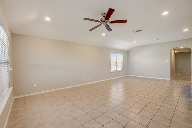 2113 Rubin Rd, Fate, TX 75189 - spare room featuring arched walkways, lofted ceiling, a ceiling fan, recessed lighting, and baseboards