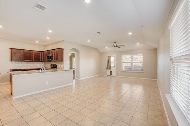 2113 Rubin Rd, Fate, TX 75189 - kitchen featuring stainless steel appliances, arched walkways, a ceiling fan, decorative backsplash, and recessed lighting
