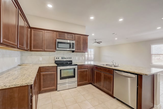 2113 Rubin Rd, Fate, TX 75189 - kitchen featuring stainless steel appliances, a peninsula, healthy amount of natural light, a sink, and recessed lighting