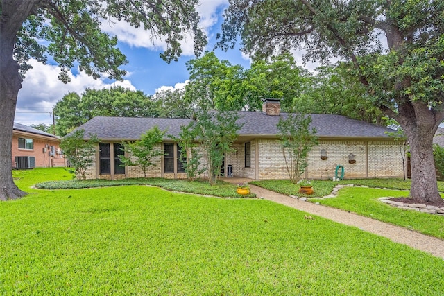 2309 Merrimac Dr, Plano, TX 75075 - single story home featuring brick siding, a front yard, a chimney, and central air condition unit