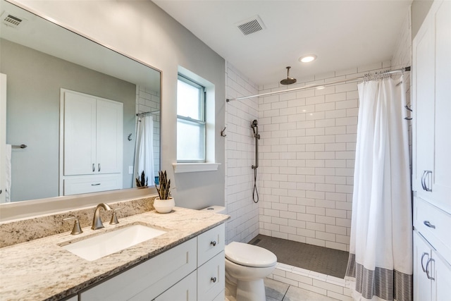 2309 Merrimac Dr, Plano, TX 75075 - full bath featuring vanity, a tile shower, toilet, and recessed lighting
