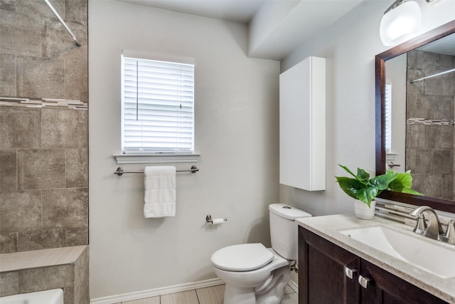2309 Merrimac Dr, Plano, TX 75075 - bathroom featuring toilet, vanity, a tile shower, and baseboards