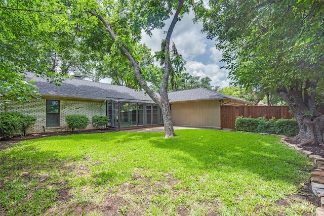 2309 Merrimac Dr, Plano, TX 75075 - back of property with a sunroom, a shingled roof, and brick siding