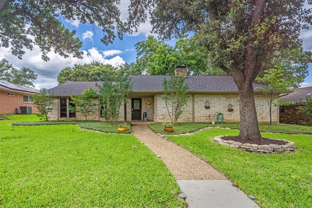 2309 Merrimac Dr, Plano, TX 75075 - ranch-style house featuring a front yard, a chimney, brick siding, and a shingled roof