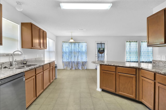8300 Southern Prairie Dr, Fort Worth, TX 76123 - kitchen featuring dishwasher, a sink, a peninsula, light stone countertops, and brown cabinets